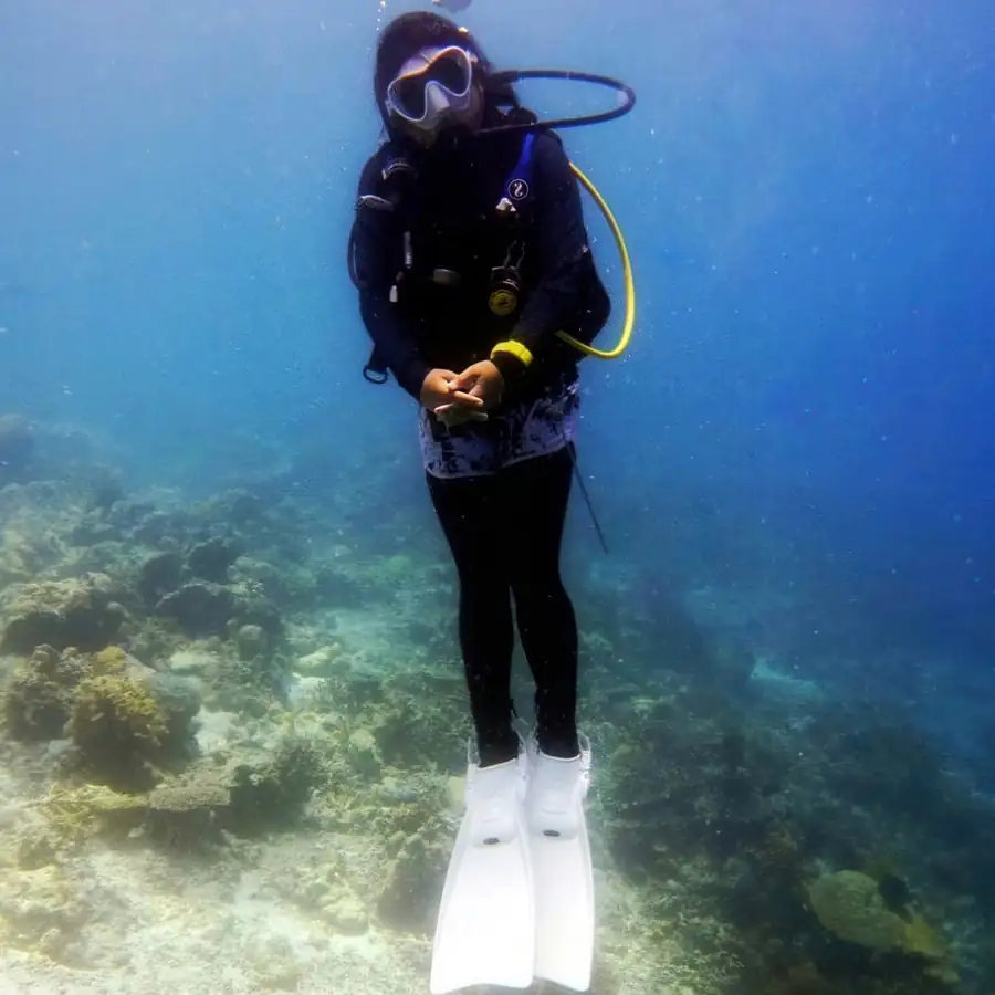 Female scuba diver exploring the reefs of Mabul Island Orange Wave Resort